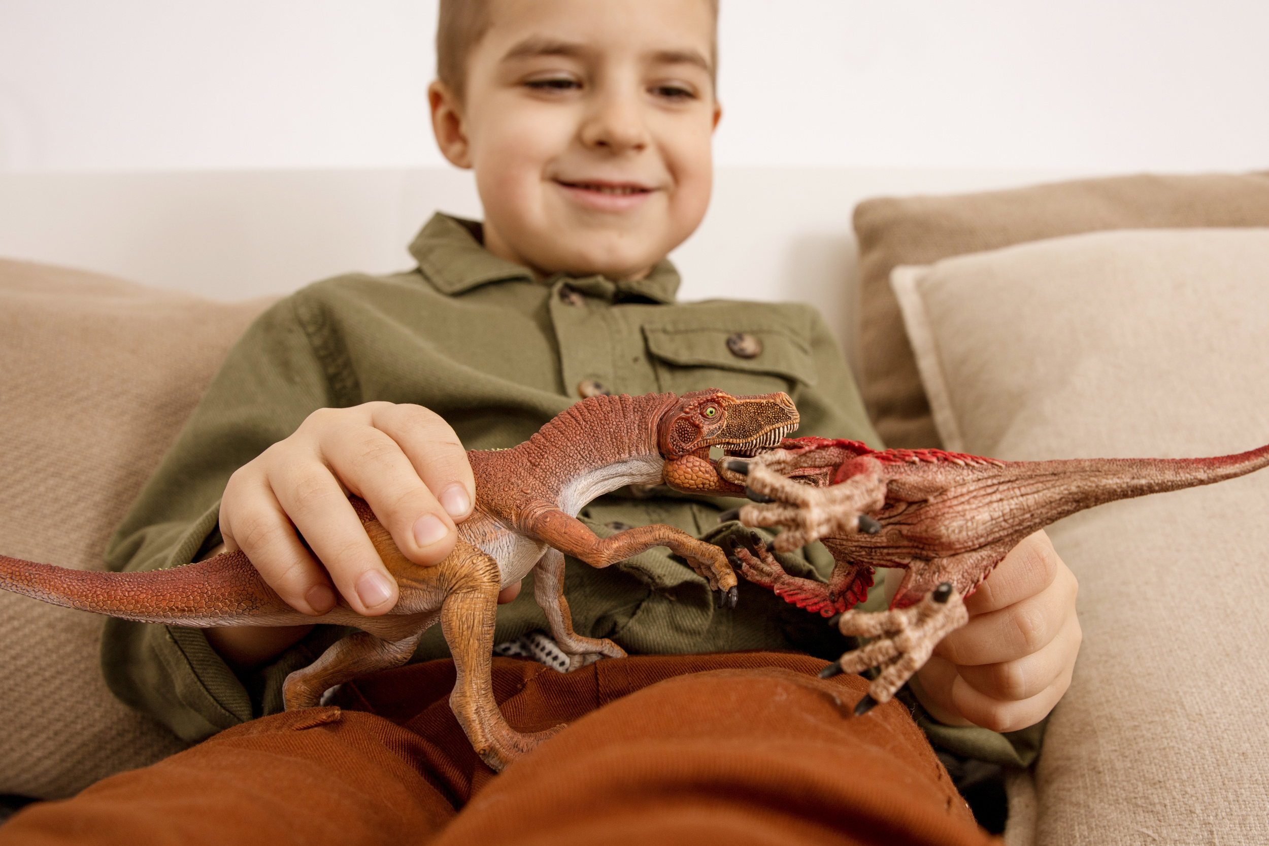 1 little-cute-caucasian-boy-playing-with-dinosaurs-home-interior-clothes-natural-colors.jpg
