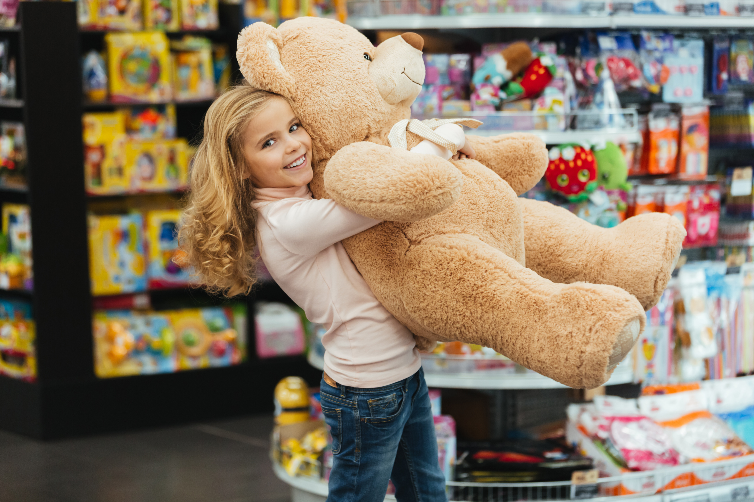 smiling-little-girl-holding-big-teddy-bear.jpg