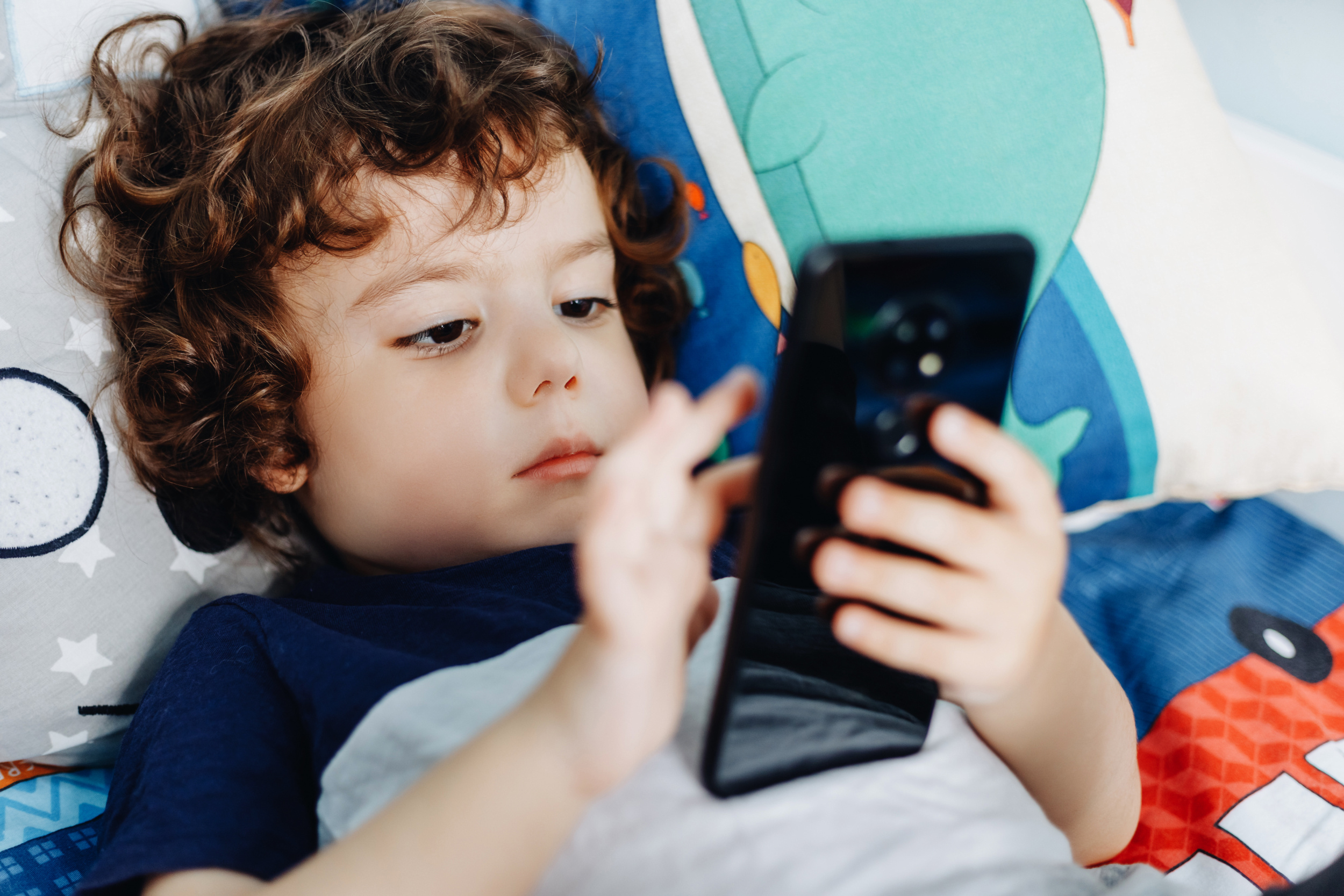 2 wow-i-like-that-phone-baby-with-smartphone-boy-sitting-bed-playing-with-mobile-phone-calling-my-mom-cute-little-baby-holds-mobile-phone-his-hands-looking-attentively-screen.jpg