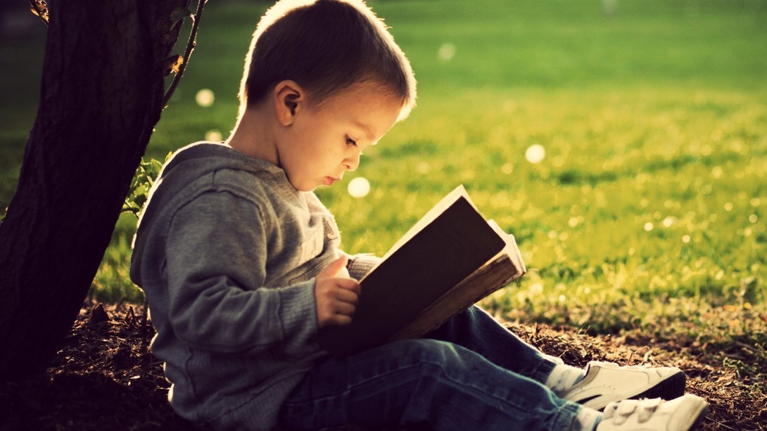 Трехлетний ребенок с книгой Трехлетний ребенок с книгой